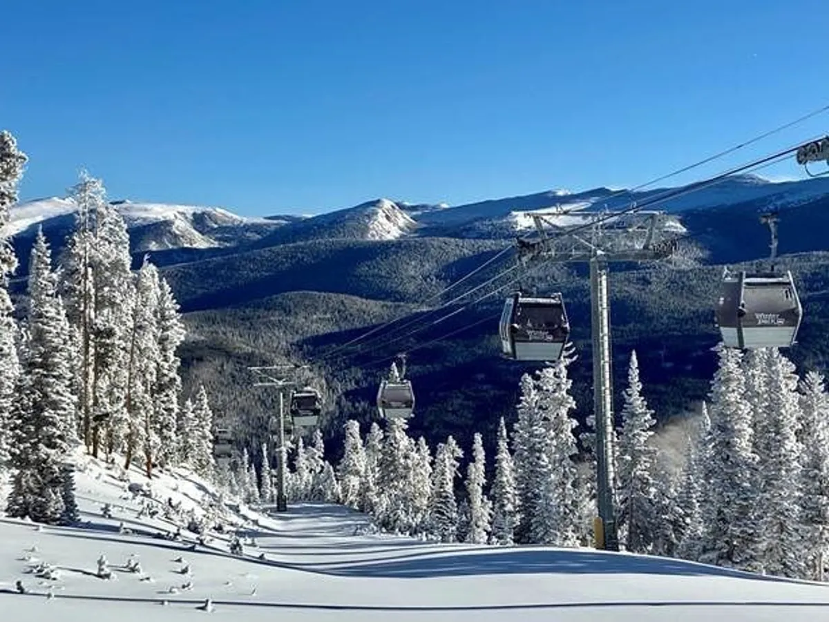 This exterior image captures ski lifts ascending snow-covered mountains, flanked by serene pine trees. The scene is bustling with winter activity, set against breathtaking alpine views that epitomize the excitement of outdoor mountain adventures.